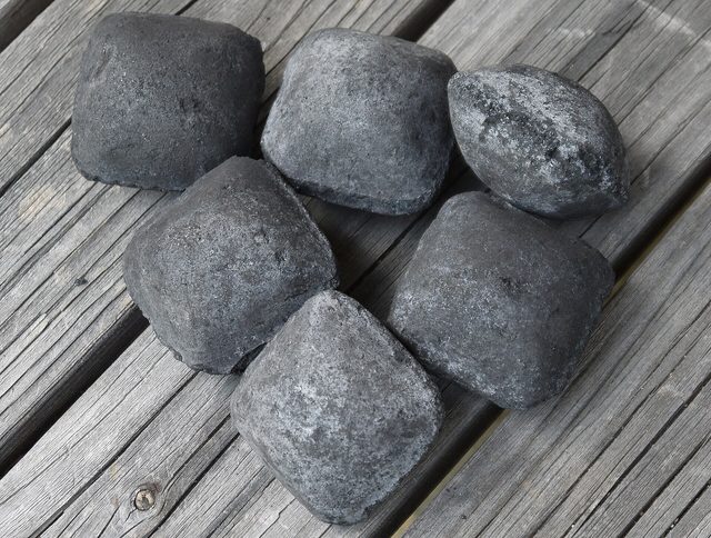 Black pillow-shaped carbon briquettes